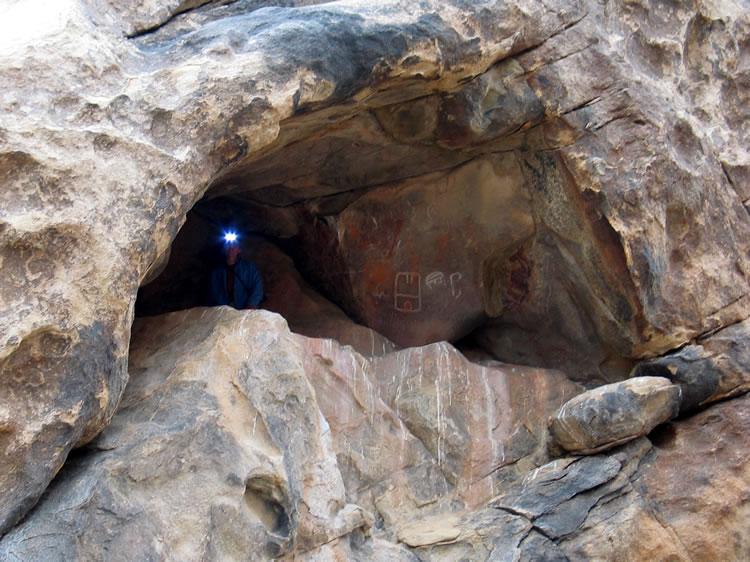A telephoto of Niki and her headlamp in the cave.