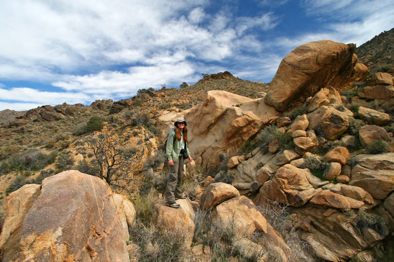 There's a bit of an optical illusion going on in this shot.  Niki is actually standing at the edge of a deep, narrow fissure through which a small stream is trickling.  The boulder pile to her left is actually on the other side of the ravine.