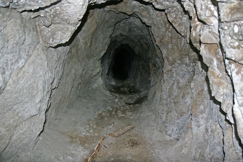 Once past the shaft, the tunnel takes on a different character.  Water now drips from the ceiling and the floor becomes increasingly muddy.