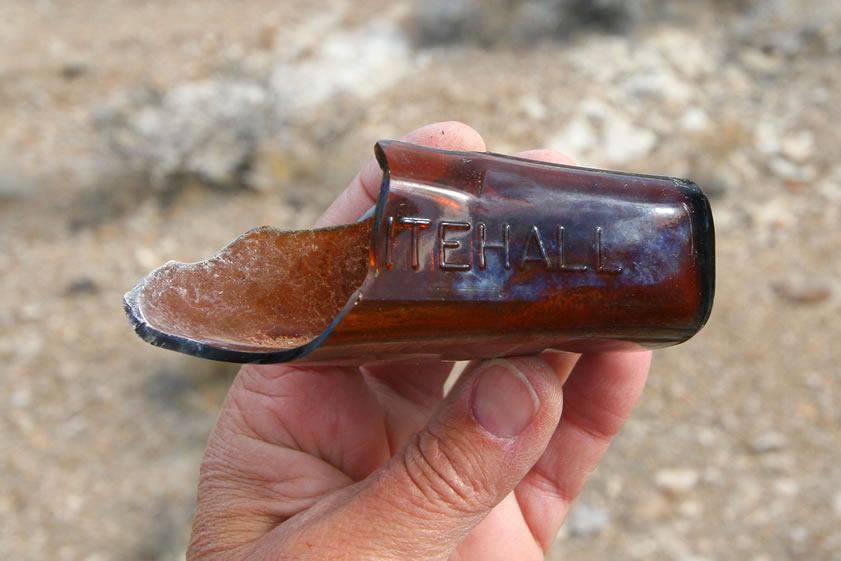 Part of an old amber Whitehall bottle.