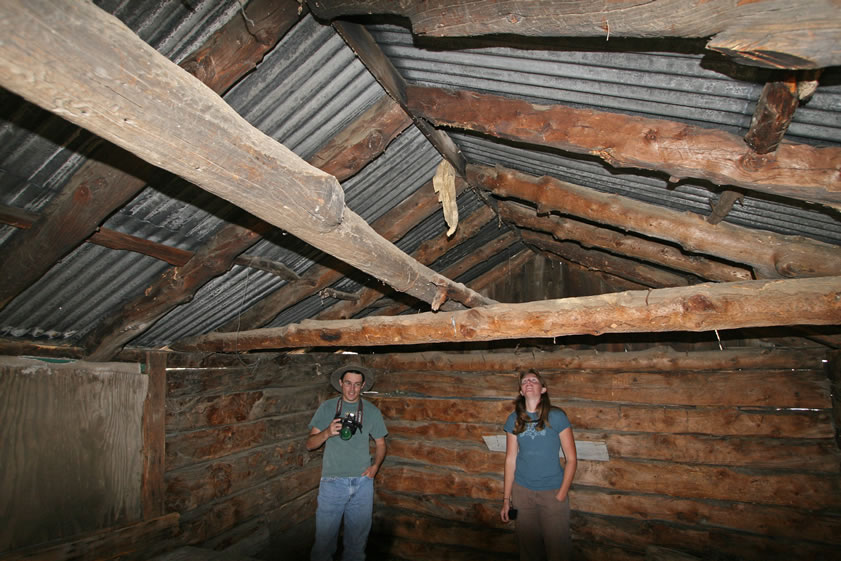 Guy and Niki check out the corrugated iron roof resting on a pole frame.  The cabin is about 20 x 12 feet and was most likely used during the spring and summer when Hunter grazed his pack animals in the lush meadows that abound in the area.