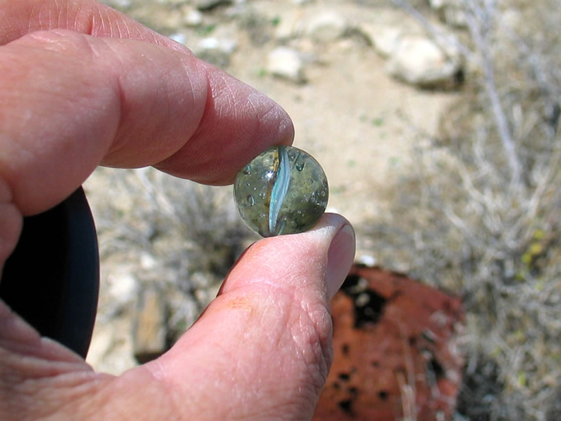 Jamie finds a marble in the ruins.