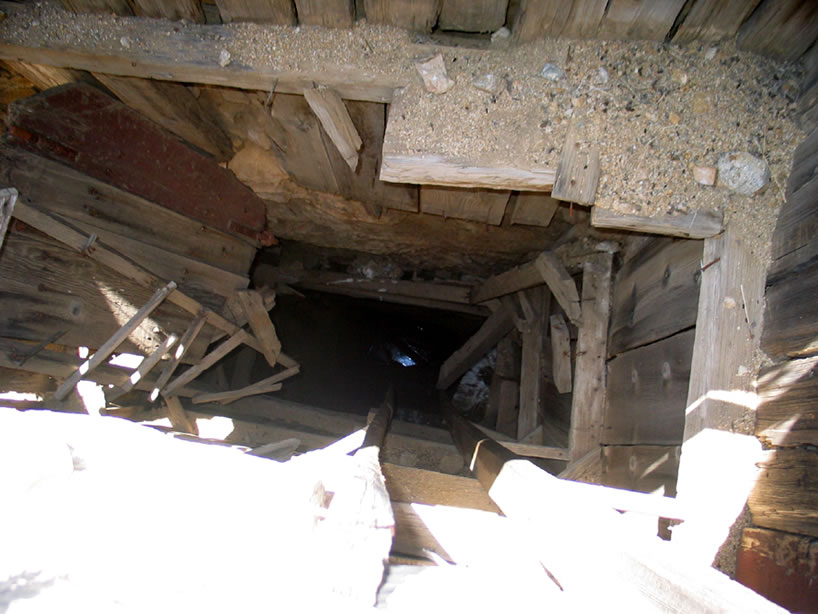 At the very bottom of the shaft you can catch a glimpse of water.