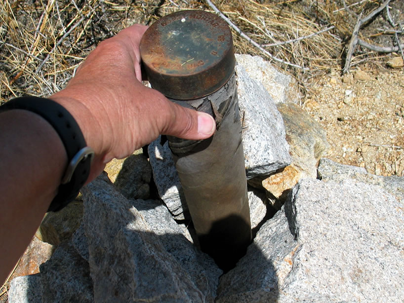 Jamie finds an old claim marker in a cardboard mortar tube.  It attests to the fact that the required yearly maintenance had been done to keep the claim valid.  Of course this predates the inclusion of this area in the Old Woman Mountains Wilderness Area and the claim is no longer valid since all mining has now ended.